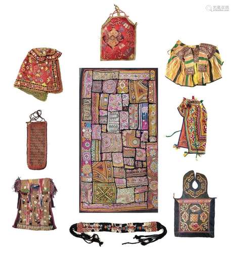 Eight Uzbekistan textiles to include two coats and a bed cov...