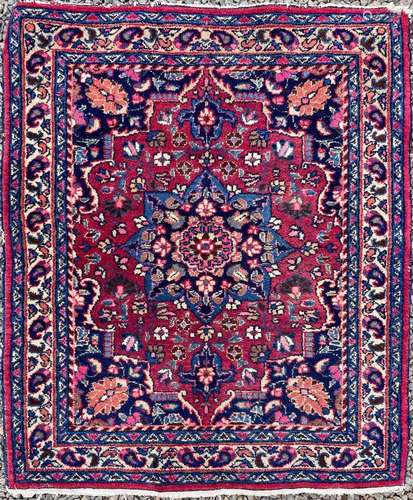 A Mashad rug, North East Persia, the madder field with a cen...