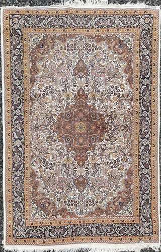 A Tabriz rug, North West Persia, the ivory field with a brow...