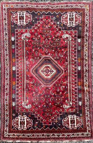 A Shiraz rug, South West Persia, the madder field with an he...