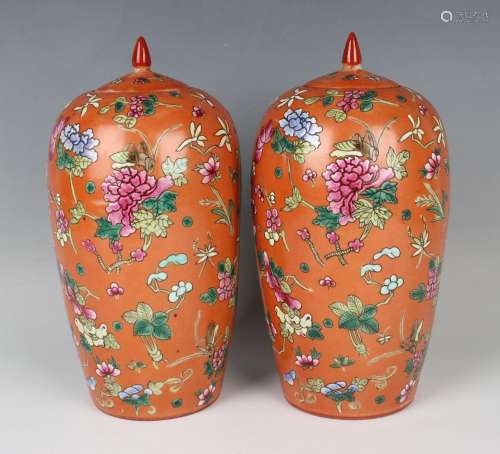 A pair of Chinese famille rose coral ground porcelain jars a...
