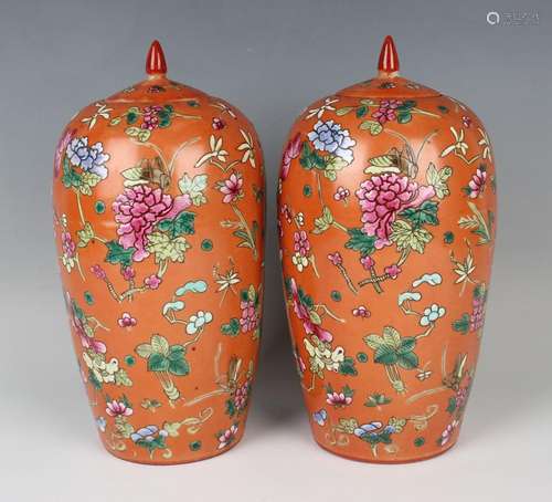 A pair of Chinese famille rose coral ground porcelain jars a...