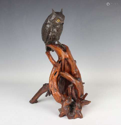 A Japanese bronze okimono figure of an owl perched upon a na...