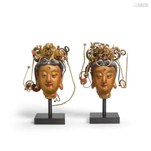 A PAIR OF PAINTED POTTERY HEADS OF BODHISATTVAS WITH WIRE AN...