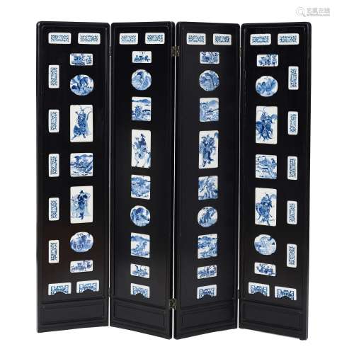 A FOUR-PANEL MIXED WOOD FOLDING SCREEN WITH INSET BLUE AND W...