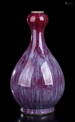 A FLAMBE GLAZED PORCELAIN BOTTLE VASE
China, 20th century