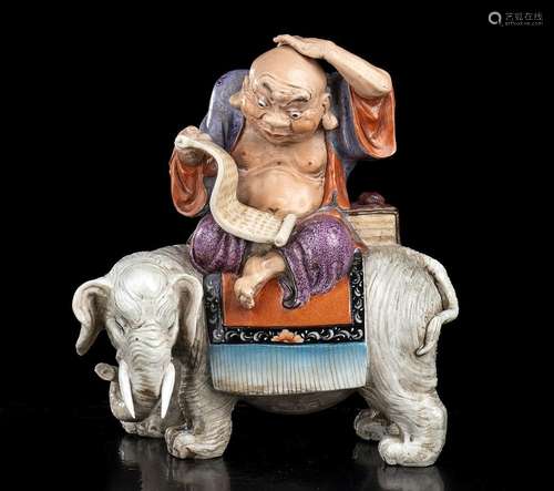 AN ENAMELLED PORCELAIN LOHAN ON AN ELEPHANT
China, 20th cent...