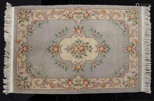 A POLYCHROME CARPET WITH FLORAL DECORATION
China, 20th centu...