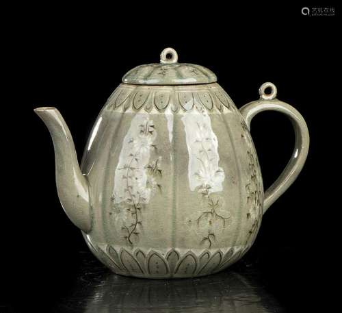 A WHITE AND BROWN SLIP INLAID AND CÉLADON GLAZED CERAMIC EWE...