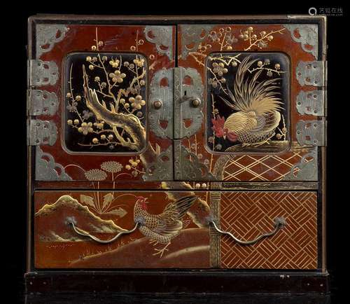 A SMALL LACQUERED AND GILT WOOD CABINET WITH METAL PLAQUES
J...