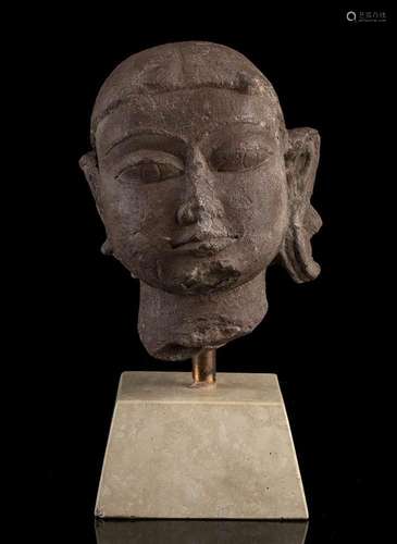 A RED STONE HEAD OF A FEMALE DEITY  
India, Medieval epoch