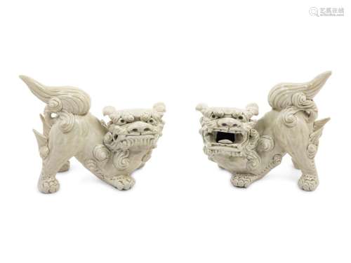 A Pair of Chinese White Glazed Porcelain Figures of Fu Lions