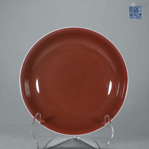 A red glazed porcelain plate