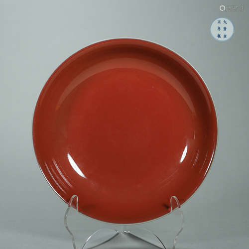 A red glazed porcelain plate