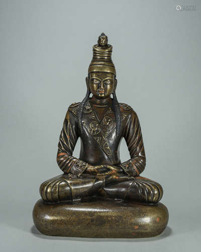 A silver-inlaid copper buddha statue