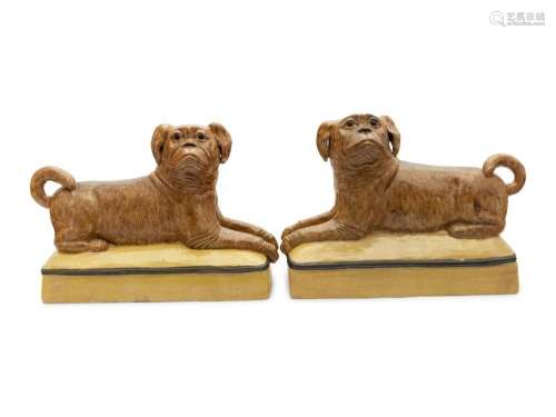A Pair of Continental Ceramic Figures of Recumbent Pugs