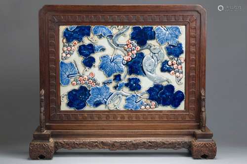 A blue and white squirrel and grape porcelain screen