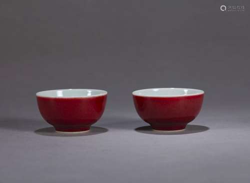 A pair of red glazed porcelain tea cups