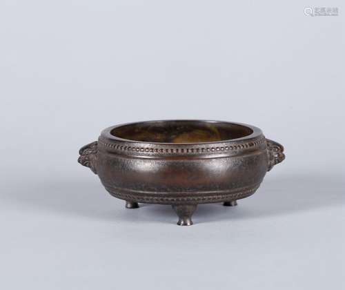 A copper censer with lion shaped ears