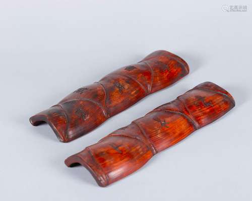 A pair of carved bamboo arm rests