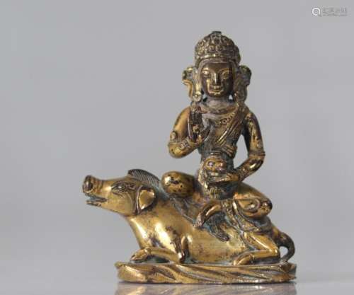 Ancient Sino-Tibetan gilt bronze statue of deity on an anima...