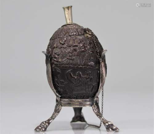 Coconut powder flask sculpted with figures. Silver base