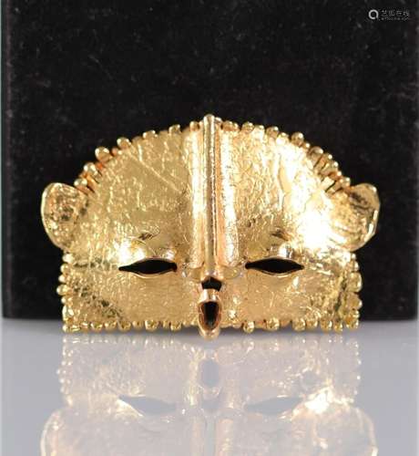 Brooch forming a signature mask to identify