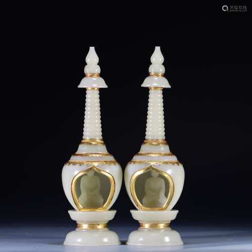 A pair of gilt pagodas from Hetian jade and silver