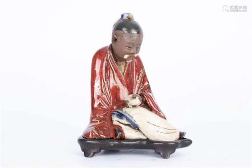 Wan kiln red glazed Gaoshi statue with Zitan base, 18th cent...