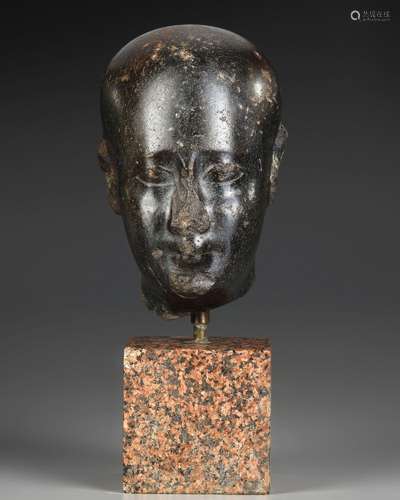 AN EGYPTIAN DIORITE HEAD OF AN OFFICIAL, LATE PERIOD, 30TH D...