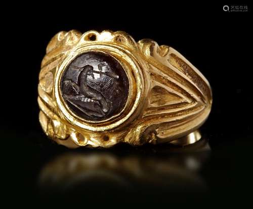 A ROMAN GOLD RING WITH DARK GREEN JASPER INTAGLIO, CIRCA 3RD...