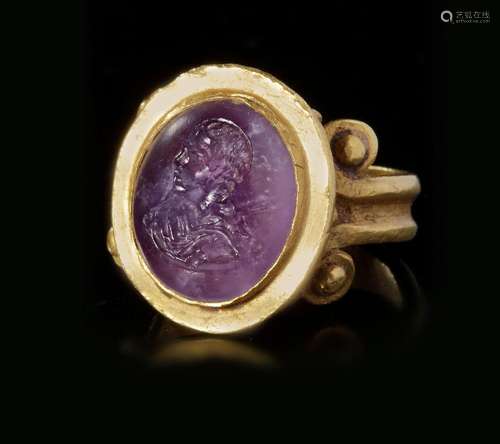 A ROMAN GOLD RING WITH AMETHYST INTAGLIO, CIRCA 2ND-3RD CENT...