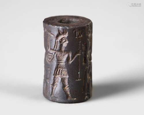 A WESTERN ASIATIC HEMATITE CYLINDER SEAL, CIRCA 1900-1700 B....