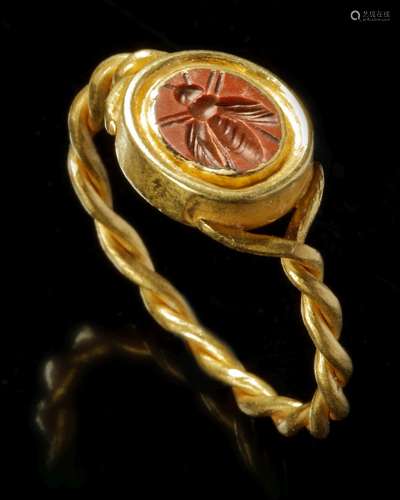 A ROMAN RED JASPER INTAGLIO OF A BEE WITH GOLD RING, CIRCA 1...