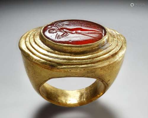 A GREEK GOLD AND CARNELIAN FINGER RING WITH CUPID, HELLENIST...