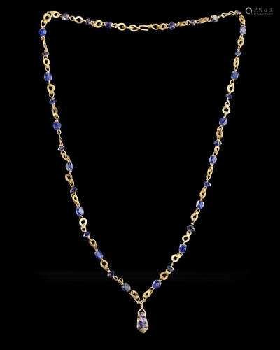 A ROMAN GOLD NECKLACE WITH BLUE GLASS BEADS, CIRCA: 1ST-2ND ...