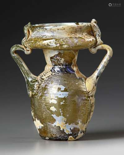 AN INTACT ROMAN OLIVE YELLOW GLASS TWIN-HANDLED JAR, CIRCA 4...