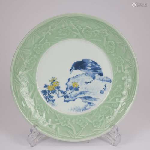 A celadon-glazed blue and white 'floral and birds' dish