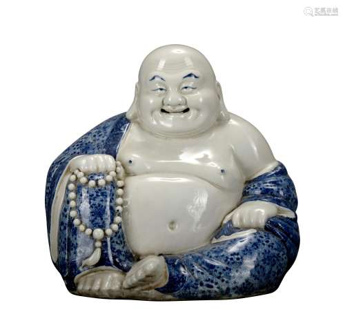 A blue and white statue of Maitreya Buddha