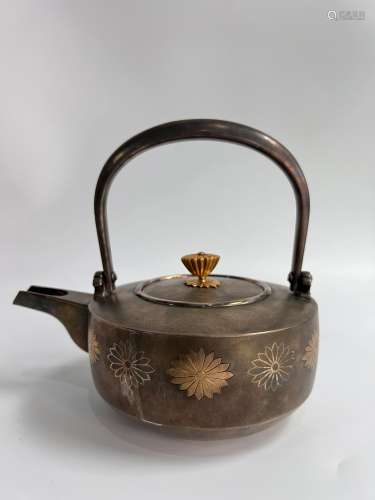 A silver Japanese teapot, stamped, it is said belongs to a f...