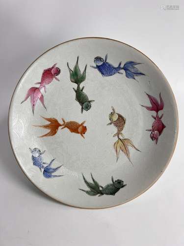 A fish decorated and with white waves incripted dish, marked...