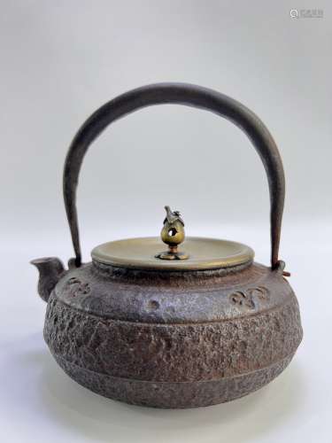 A Japanese iron teapot, signed, it is said belongs to a famo...