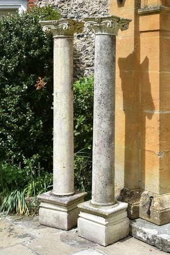 A LARGE PAIR OF CAST STONE COLUMNS WITH SCROLLING FLORAL CAP...