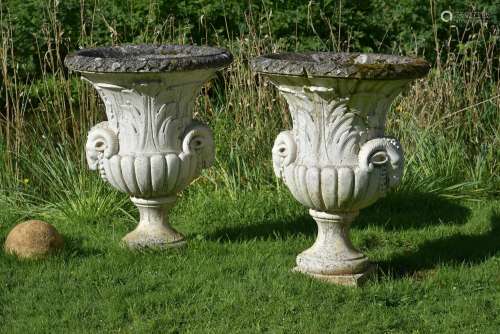 A PAIR OF WHITE PAINTED COMPOSITION URNS, IN THE NEOCLASSICA...