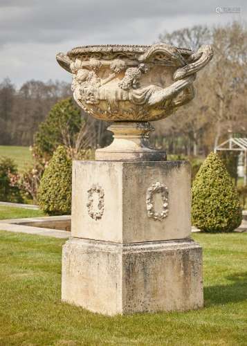 A LARGE CAST STONE WARWICK VASE AND PEDESTAL IN THE MANNER O...