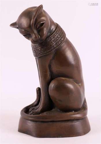 A brown patinated bronze sitting cat, 20th century.
