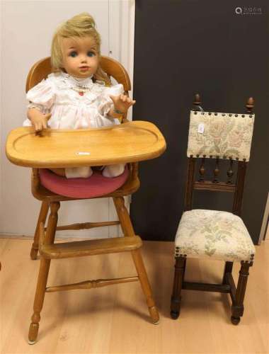 A doll in a high chair and a doll's chair, 20th century.