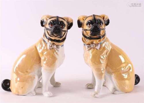 A pair of gold glazed porcelain 'Pug' dogs with muzz...