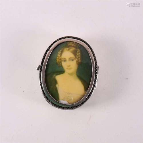 An oval silver pill box with a portrait of a young lady, cir...