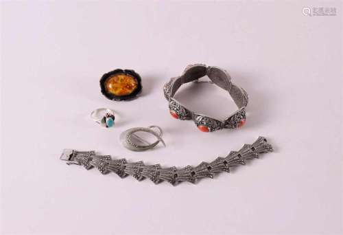 A filigree silver bracelet with cabochon cut red corals.